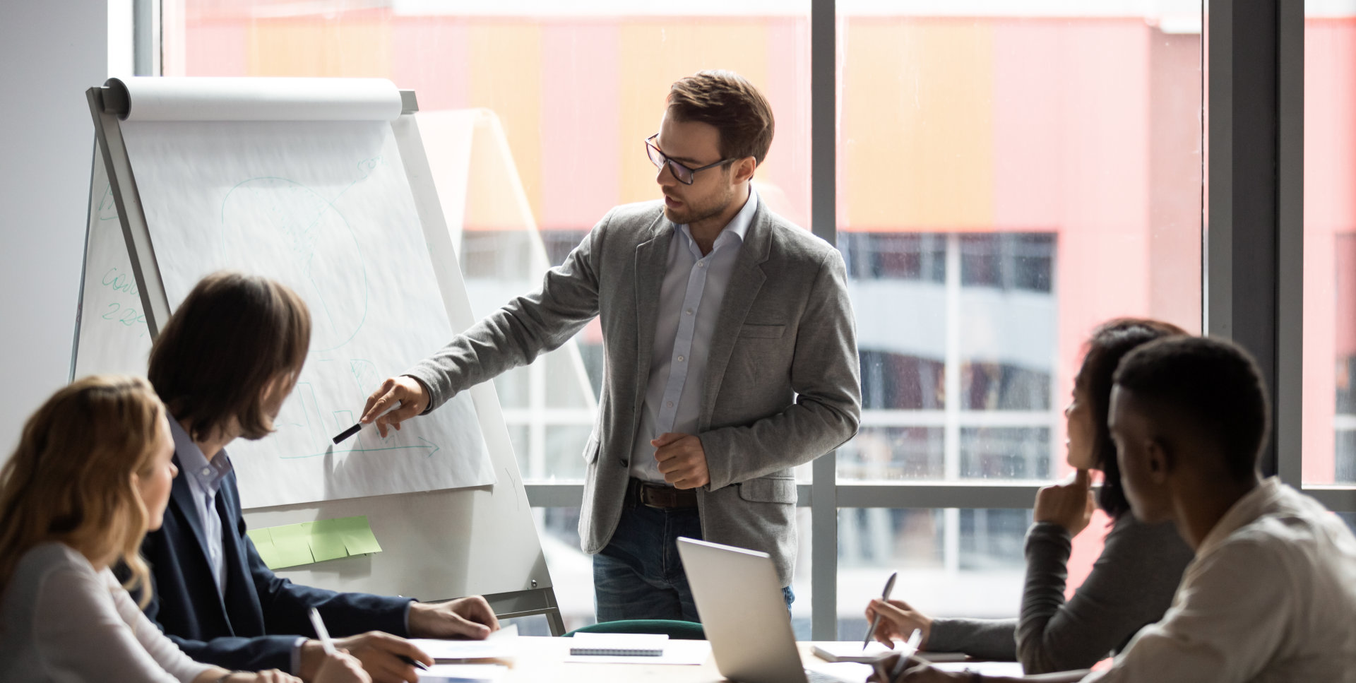 a male professional having a presentation in front of a group