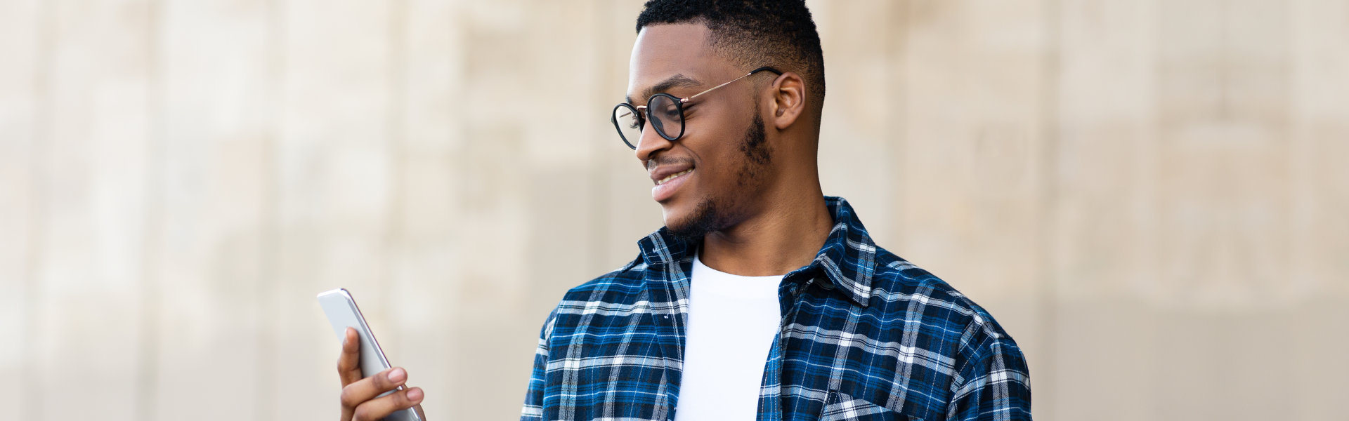 A male holding a mobile phone